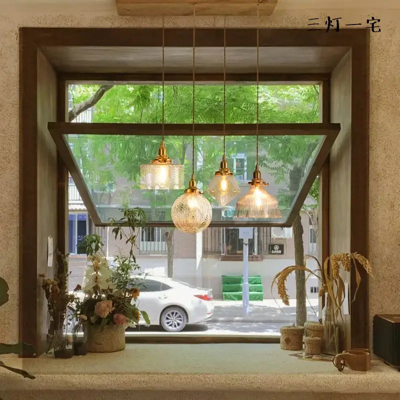 Three warm-toned modern brass and clear glass led pendant lights with textured shades for dining room decorbites clear glass