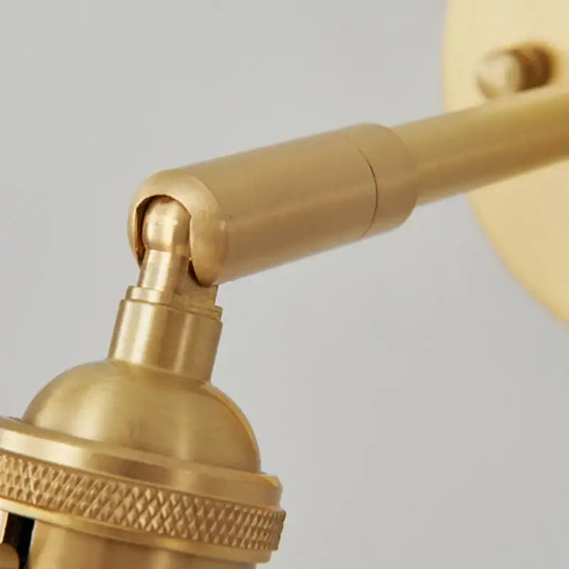 Modern brass and clear glass wall lights featuring a brass-finished adjustable wall sconce with knurled base for bedroom decorbites clear glass