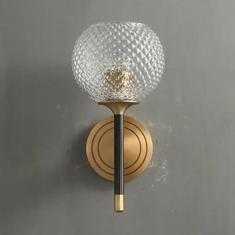 A modern brass and copper wooden wall light with a clear textured glass globe and copper wooden frame decorbites design