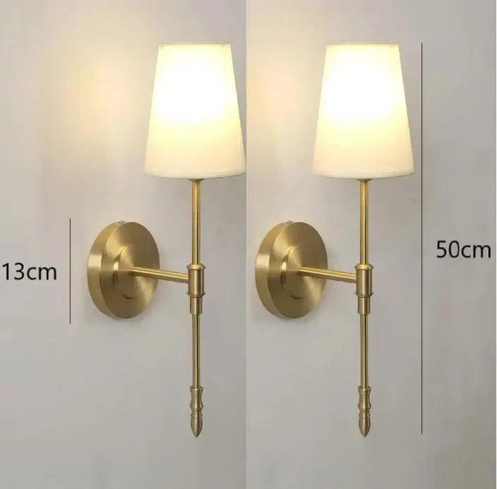 Modern brass and cream fabric led wall lamps featuring a brass-finished wall sconce with cream fabric shade for bedroom lighting