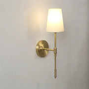 Modern brass and cream fabric led wall lamp with brass finish and cream shade ideal for bedroom wall lamps