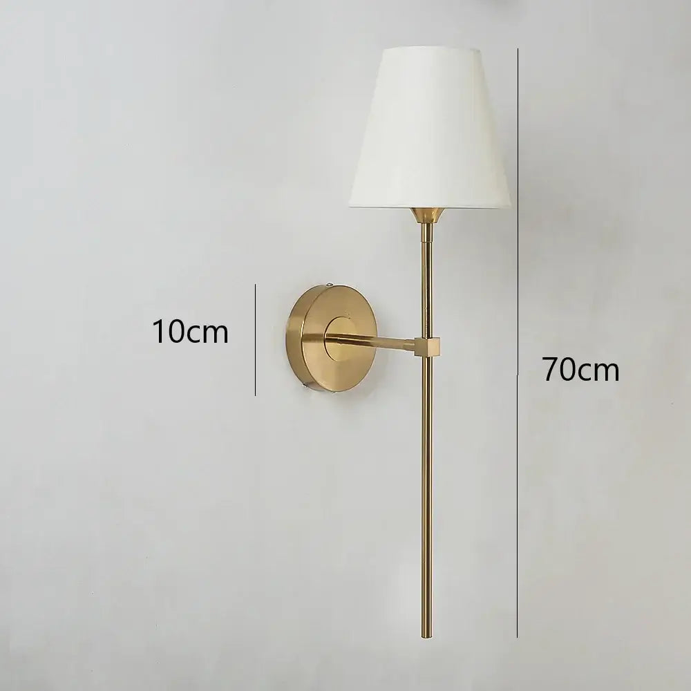 Modern brass led wall lamp with cream fabric shade for bedroom featuring a gold finish and LED lighting