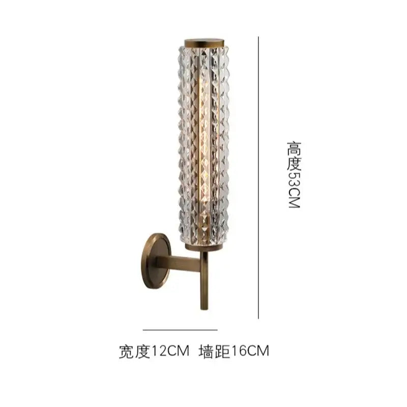 Modern brass and crystal copper wall sconce with a textured glass cylinder and brass mounting bracket for living room lighting