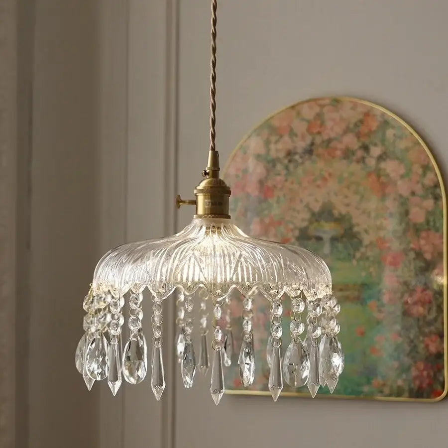 Modern brass and crystal glass led pendant lamp featuring clear glass chandelier with brass fixture and crystal teardrop pendants