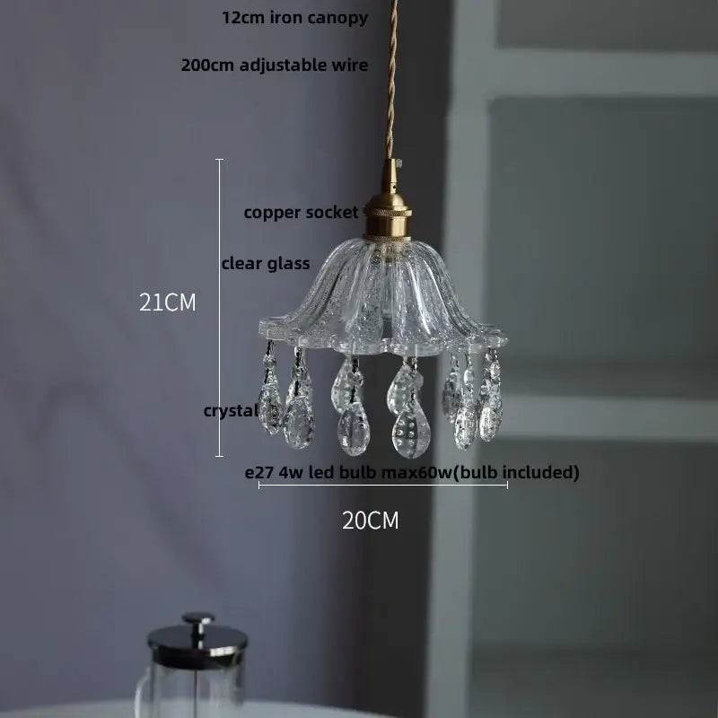 A modern brass and crystal glass led pendant lamp with clear glass shade and crystal droplets for dining room decorbites