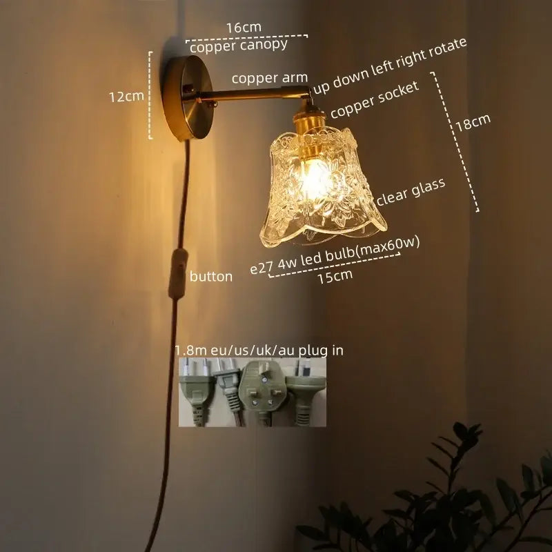 Modern brass and crystal led wall lamp with antique brass-finished copper sconce, clear etched glass shade, and adjustable arm