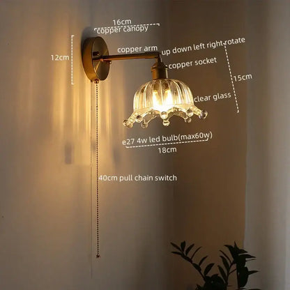 Copper-finished modern brass and crystal led wall lamp with clear glass petal ridges and dangling crystal accents for bedroom