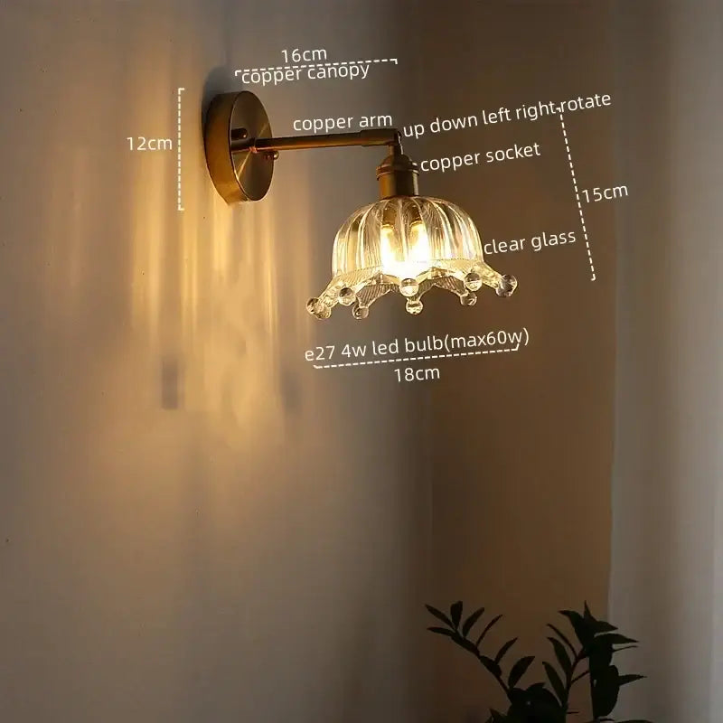 Modern brass and crystal led wall lamp with copper finish clear fluted glass shade and dangling crystal accents for bedroom