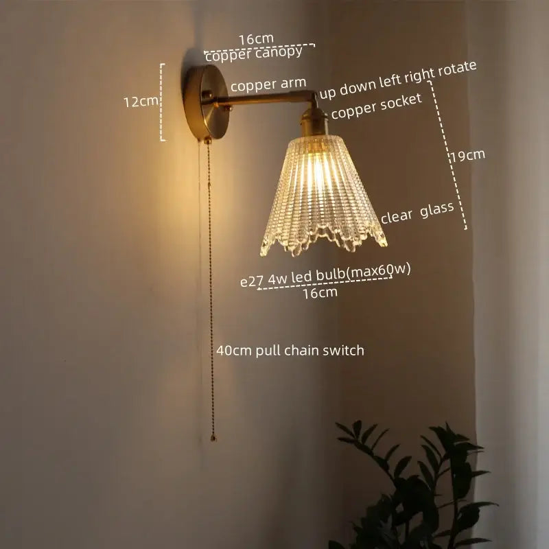 Modern brass and crystal led wall lamp with copper sconce and clear glass shade featuring vertical ridges and scalloped edges