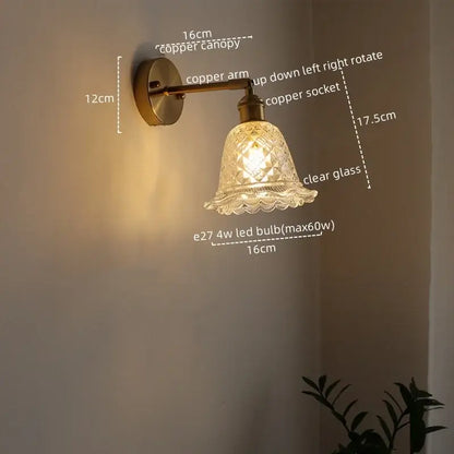 Modern brass and crystal led wall lamps featuring a vintage-style copper wall sconce with a clear cut glass shade