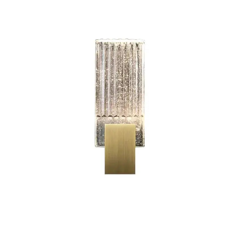 Modern brass and crystal wall light with clear textured glass panel featuring vertical ridges and sparkling particles