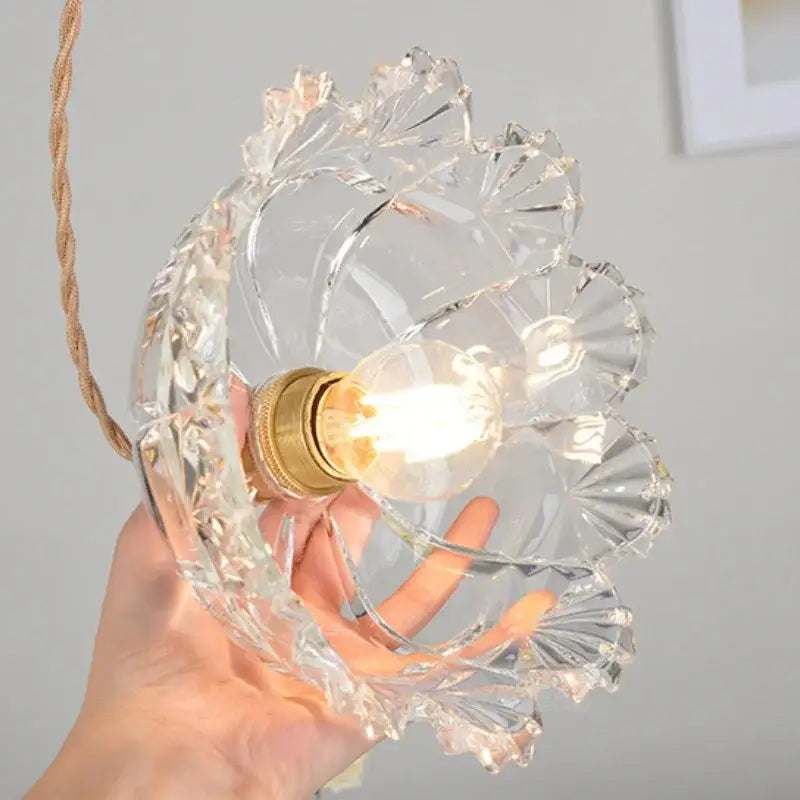 Modern brass and cut glass led pendant light with clear intricate glass and exposed filament bulb for dining room