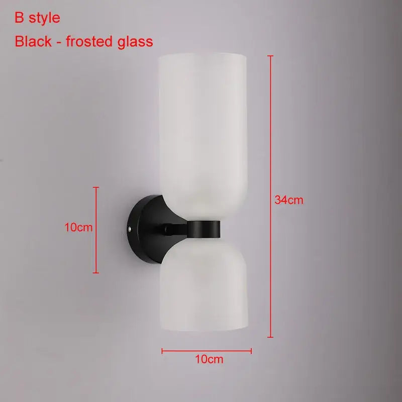 Modern brass wall lamps featuring black-frosted decorbites glass ball shades for stylish bedroom sconces