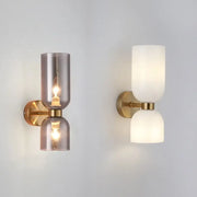 Modern brass wall lamps with decorbites glass ball shades in smoky gray and opaque white for bedroom sconces