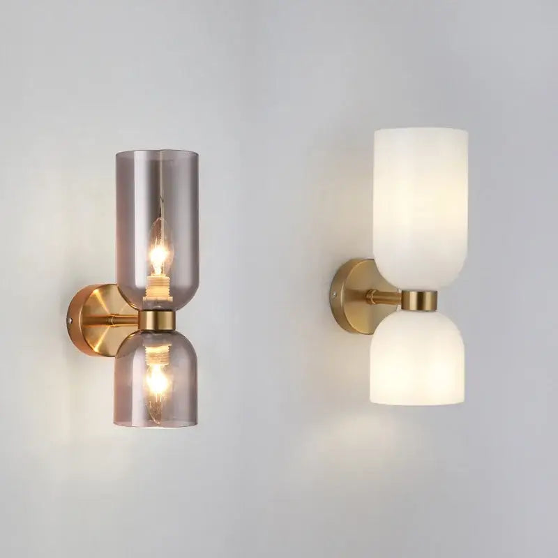 Modern brass wall lamps with decorbites glass ball shades in smoky gray and opaque white for bedroom sconces