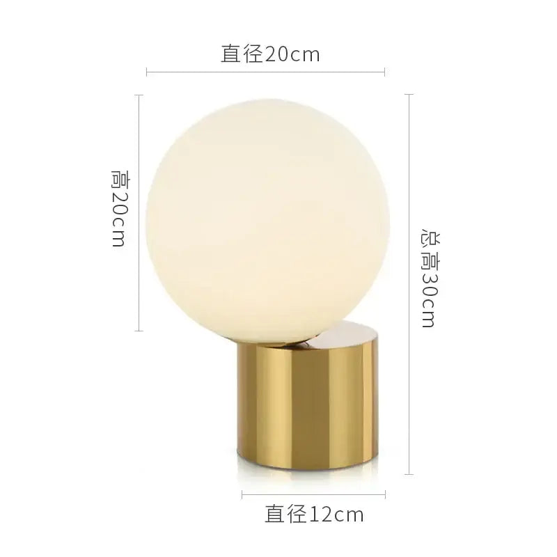Modern brass and decorbites glass circular table lamp with frosted white spherical glass globe and polished gold base