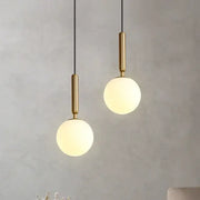 Two modern brass and frosted glass ball pendant lights with polished fixtures for dining room decorbites glass ball decor