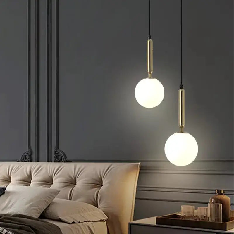 Two modern brass and frosted glass ball pendant lights with black cords for dining room decorbites glass ball pendant