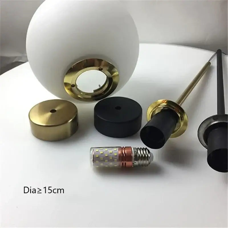 Modern brass and frosted glass ball pendant light with white spherical glass lampshade and gold-toned metal ring for kitchen decorbites glass ball pendant light