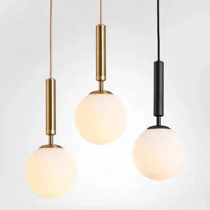 Modern brass and frosted glass pendant light with gold and black metal stems for dining room chandelier pendant light