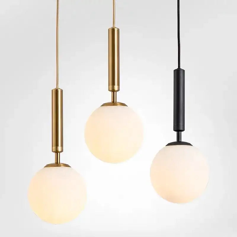 Modern brass and frosted glass pendant light with gold and black metal stems for dining room chandelier pendant light