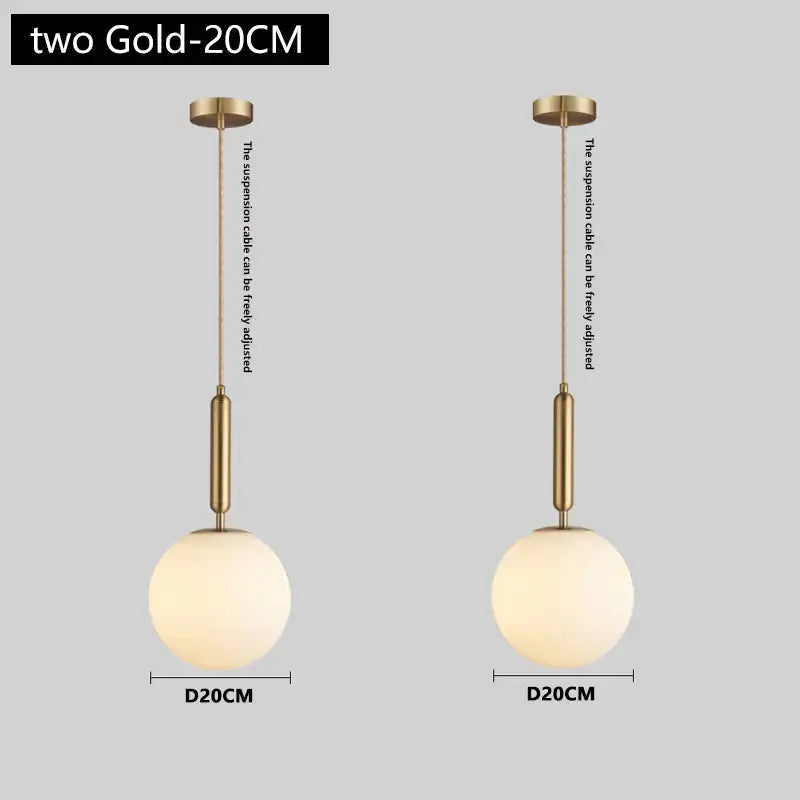 Modern brass and frosted glass pendant light with spherical gold finish and adjustable suspension cables for dining room