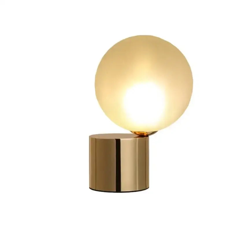 Modern brass and glass ball table lamp with a gold finish and frosted glass globe shade for bedroom bedside decorbites glass ball
