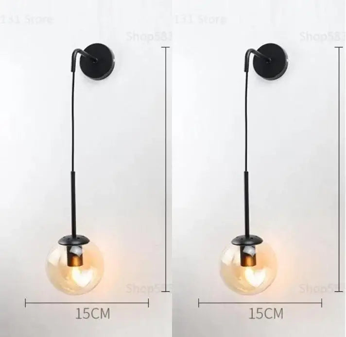 Black metal wall lamp with hanging glass ball bulb featuring modern brass and decorbites glass ball design for bedroom decor