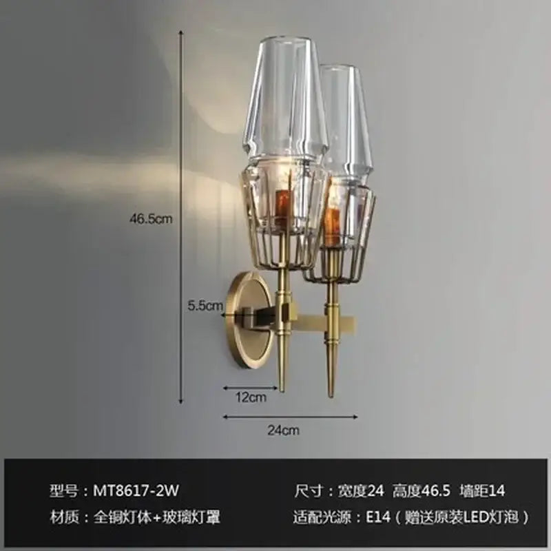 Modern brass and glass bedside table lamp wall sconce with two clear glass shades and geometric design for bedroom use