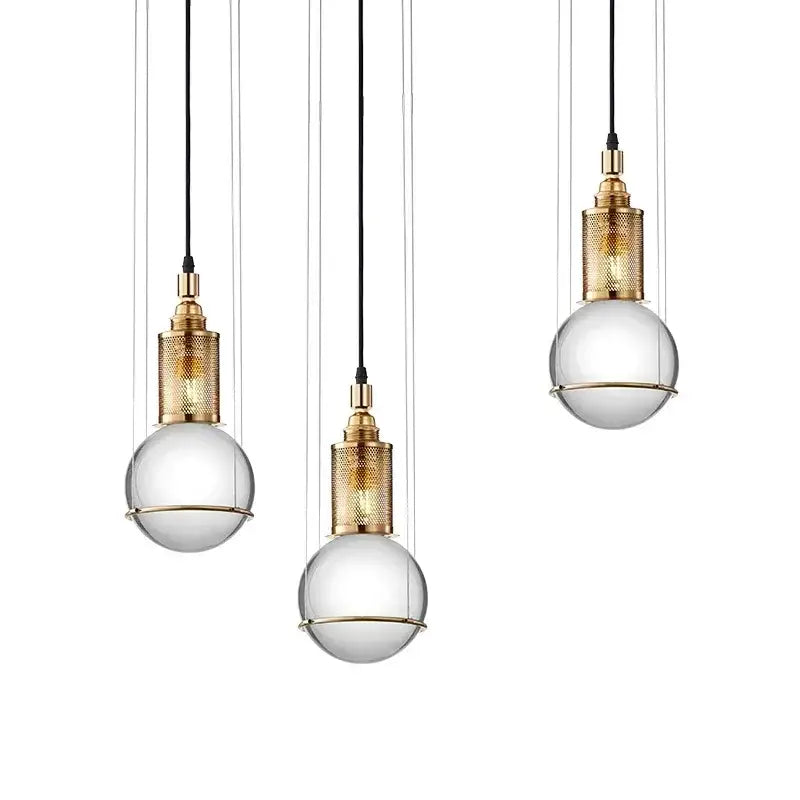 Three elegant brass-finished pendant lights with clear glass globes and black cords decorbites crystal ball led decor