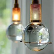 Modern brass and glass crystal ball led pendant light with a transparent globe and brass mesh top for dining room decorbites pendant light