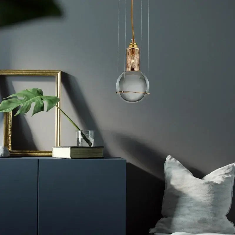 Modern brass and glass crystal ball led pendant light with clear globe and copper-toned shade for dining room decorbites crystal ball