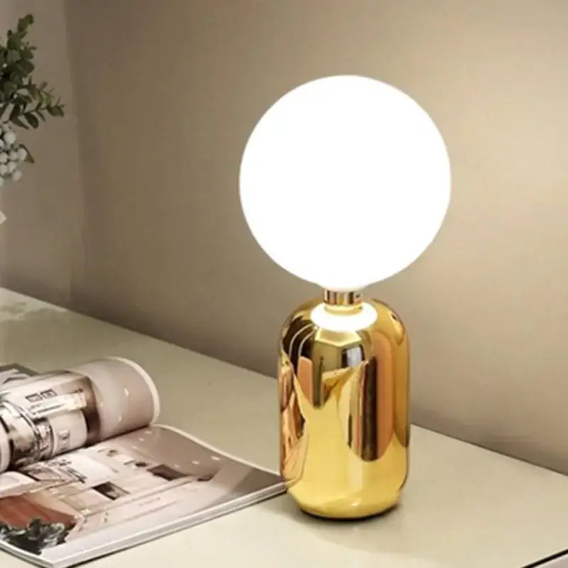 Modern brass and glass desk lamp with gold finish and spherical white glass bulb for bedroom decorbites glass desk use
