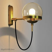 Modern brass and glass globe led wall lamp with spherical glass globe and black cord for bedroom lighting