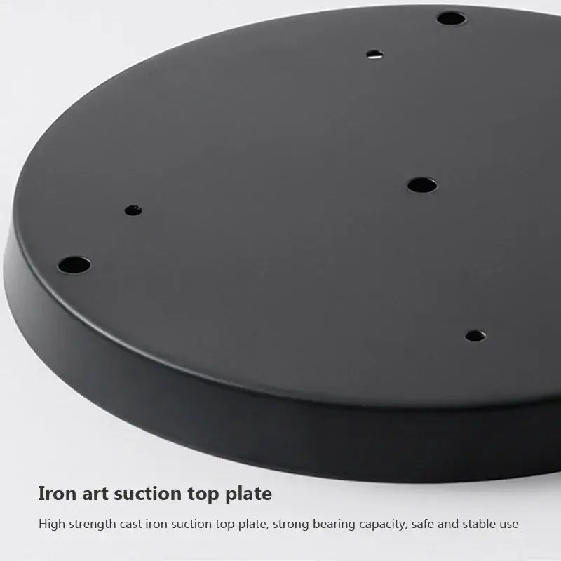 Black cast iron suction top plate with circular holes for secure attachment in modern brass and glass pendant light iron finish
