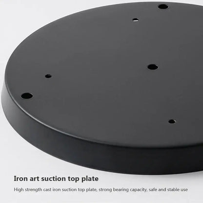 Black cast iron suction top plate with circular holes for secure attachment in modern brass and glass pendant light iron finish
