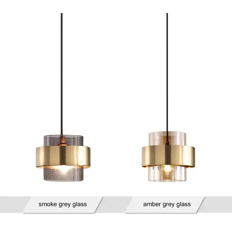 Two modern brass and amber grey glass pendant lights ideal for kitchen or dining room lighting