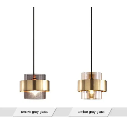 Two modern brass and amber grey glass pendant lights ideal for kitchen or dining room lighting