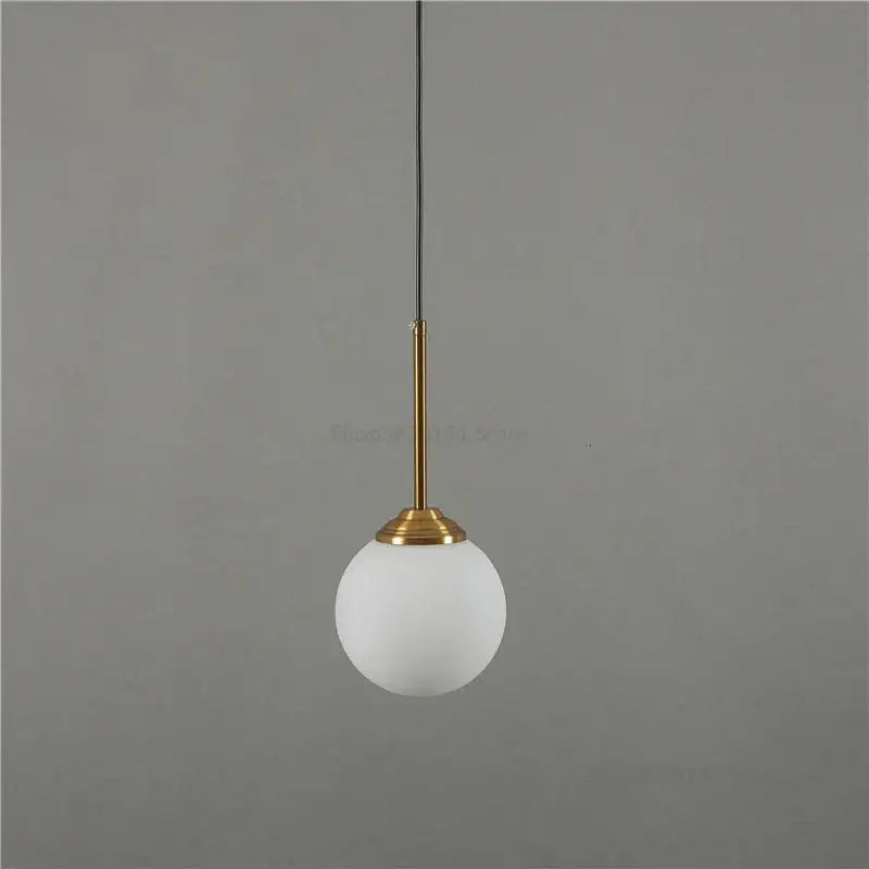 Modern brass and glass pendant light with frosted white glass globe for kitchen and dining room pendant lights