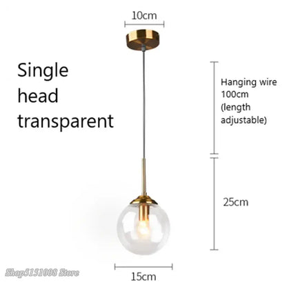 Modern brass and glass pendant lights featuring a transparent glass pendant with gold-toned fixture for kitchen dining room