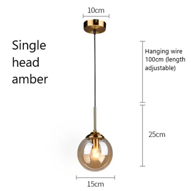 A single amber glass pendant light with a gold-toned metal fixture modern brass pendant lights for kitchen