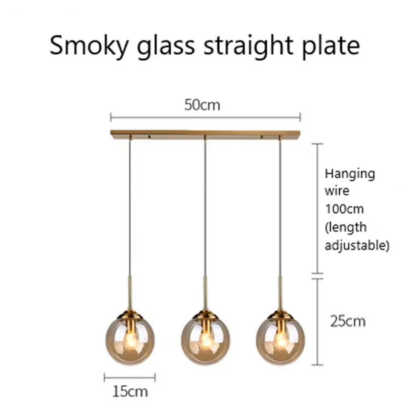 Modern brass and glass pendant lights with smoky glass pendant shades and brass metal accents for kitchen dining room