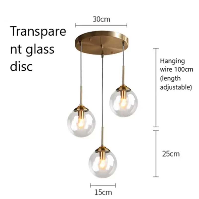 Modern brass and glass pendant lights with clear glass pendant shades and metal accents for kitchen and dining room