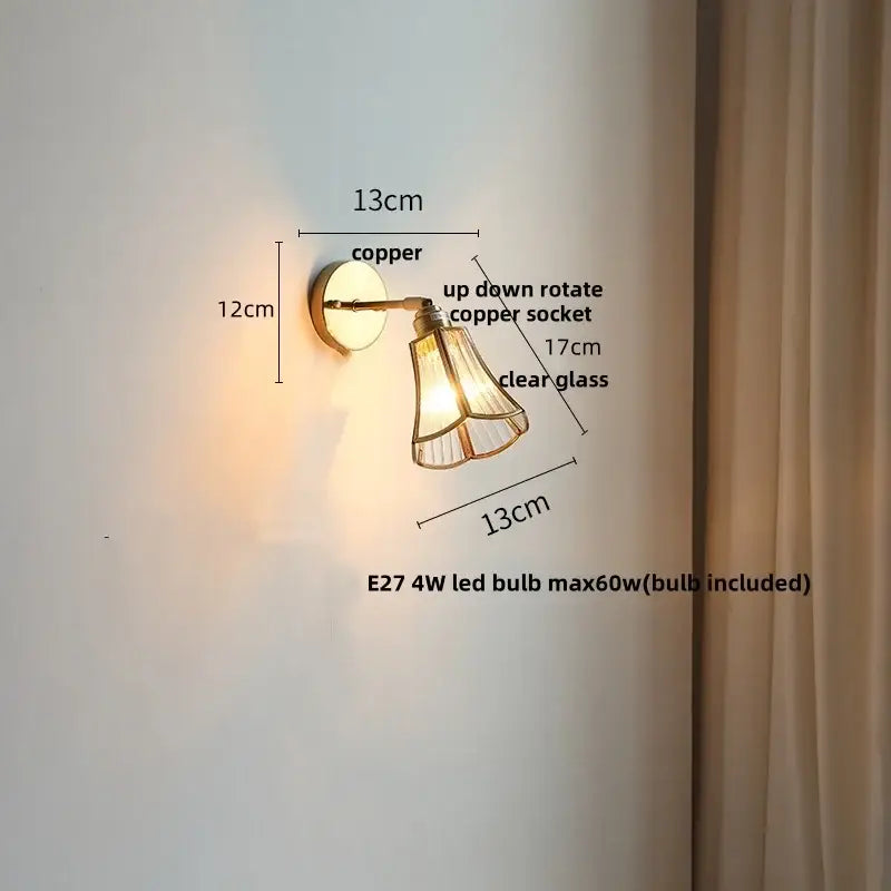 Copper-finished modern brass and gray glass led wall sconce with clear glass shade and adjustable up-down rotation