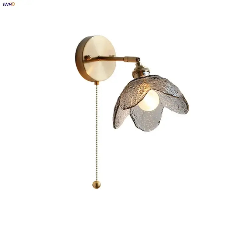 Modern brass wall sconce with gray glass led flower-shaped shade and pull chain for bedroom lighting