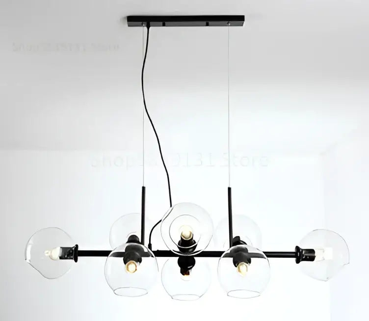 Black metal chandelier with five clear glass globe shades in modern brass and gray glass pendant lights for kitchen dining room