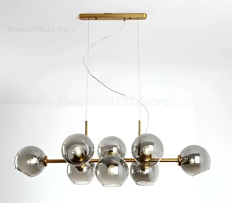 Modern brass pendant lights with seven smoked gray glass globes in a linear design for kitchen and dining room