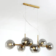 Modern brass pendant lights with spherical bulbs and gray glass pendant shades for kitchen and dining room lighting