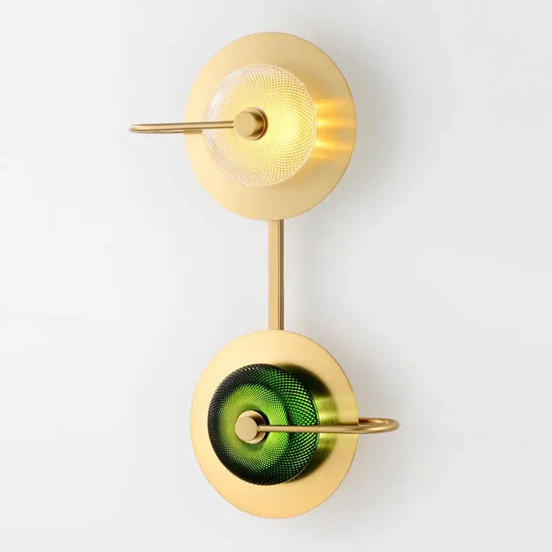 Modern brass and green glass metal wall art lamp with two circular shades mounted on slender brass stems for living room wall art