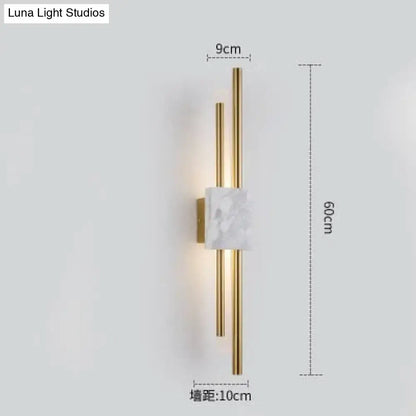 Modern brass and white marble led wall lamp with two vertical rods for living room use